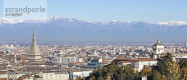 Turin  Italy  Circa November 2021: panorama with Alps and Mole Antonelliana  . Skyline of the symbol of Piedmont Region withi Monte dei Cappuccini  Cappuccini's Hill. Sunrise light  Europe