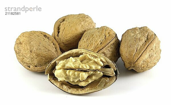 Walnuts isolated on white background. Whole and shelled nuts. Juglans regia is a valuable edible fruit