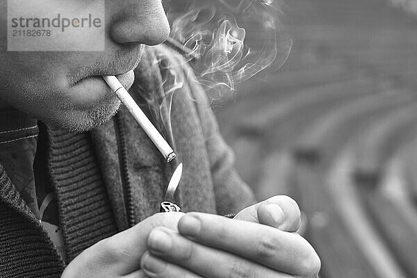 Guy smokes a cigarette outside  portrait  close-up