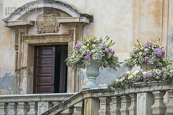 Romantic wedding bouquet in a baroque stone vase in front of the Chiesa di San Giuseppe in Taormina in Sicily  Italy  Europe