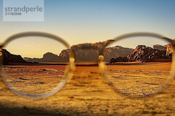 View at the Wadi Rum desert in Jordan through glasses during a nice sunset with clear sky. Travel  tourism and adventure