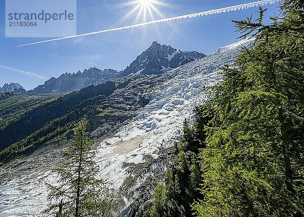 View of glacier Glacier des Bossons with sun star  behind summit of Aiguille du Midi  Chamonix  Haute-Savoie  France  Europe