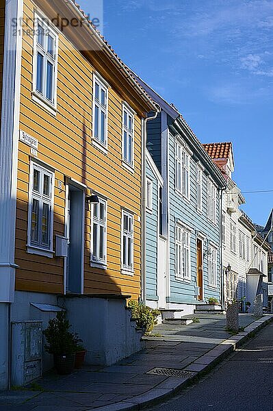 Street with colourful wooden houses and blue sky in the background  Bergen  Vestland  Norway  Europe