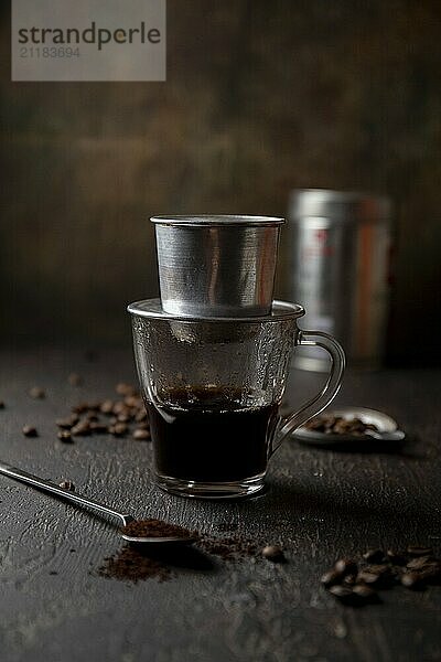 Food  Food  Preparation of Vietnamese coffe with aluminum cofe filer on dark background