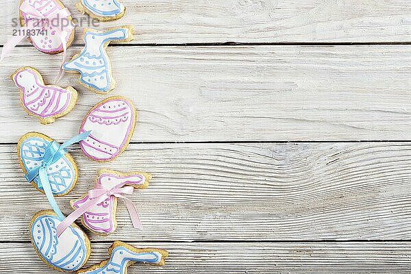 Easter frosted cookies in shape of egg chicken and rabbit on white wooden table background flat lay horizontal mockup with copy-space