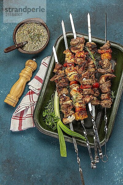 Food  Food  Bbq grilled meat pork  chicken and vegetable skewers on tray. Top view  flat lay. Blue background