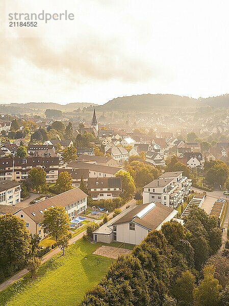 Village view at sunrise  many houses and green areas  surrounded by hills  airy and atmospheric landscape  Calw  Black Forest  Germany  Europe