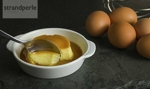 Traditional Brazilian dessert  milk pudding on dark background