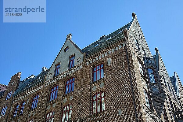 Row of historic Hanseatic houses with striking facades under a clear blue sky  Bryggen  Bergen  Vestland  Norway  Europe