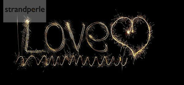 Inscription Love and heart of sparklers. Sparks of holiday lights on black background with heart and spiral