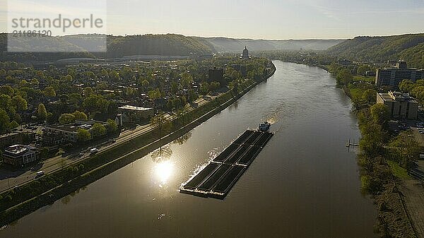 Charleston West Virgina ia an active seaport here a barge moves coal around