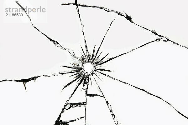 Damaged glass with cracks  cracks in the glass from the shot. Broken window  texture on a white background