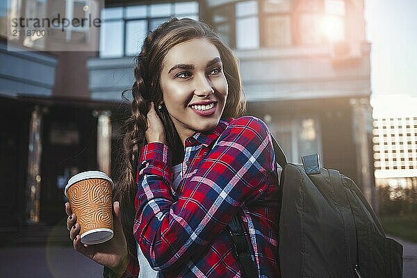 Awesome girl in urban style walk in city with coffee