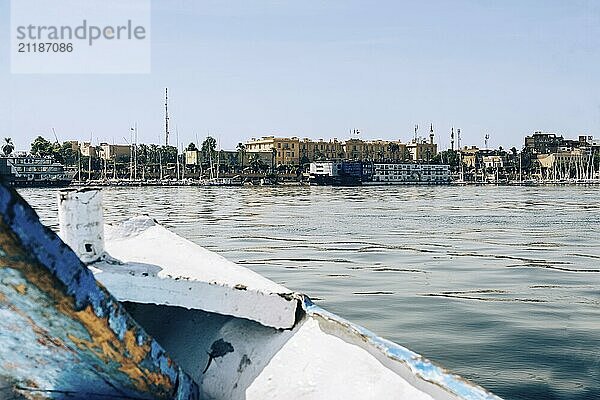 Immerse yourself in the beauty of Luxor as you sail along the tranquil waters of the Nile River. This breathtaking photo captures the bustling Luxor port  framed by the silhouette of traditional felucca boats and majestic cruise ships docked along the harbor. The cityscape provides a backdrop of vibrant colors and timeless charm. Experience the allure of Luxor's riverfront and the harmony of old and new in this picturesque scene. Perfect for travelers and admirers of Egypt's rich cultural heritage. Experience Egypt's summer allure through captivating images of the Pyramids  Sphinx  and a scenic Nile cruise from Aswan to Luxor. Immerse yourself in ancient history and vibrant landscapes