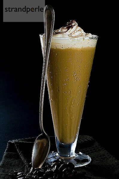 Iced coffee with cream on a black background