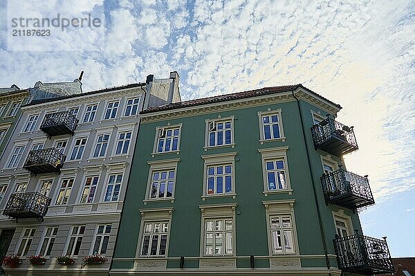 Multi-storey building with historic looking balconies and windows under a slightly cloudy sky  Bergen  Vestland  Norway  Europe