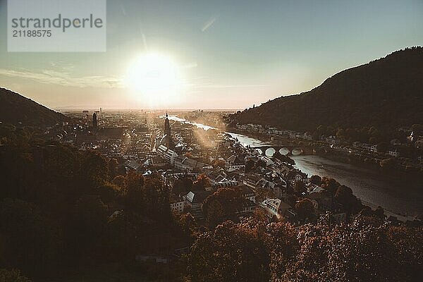 City panorama of Heidelberg at sunset with river  bridge and mountains in the background  Heidelberg  Germany  Europe