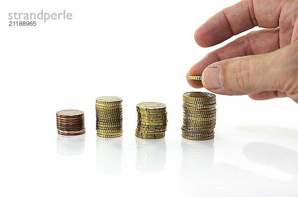 Man putting euro coin on stack money isolated on white