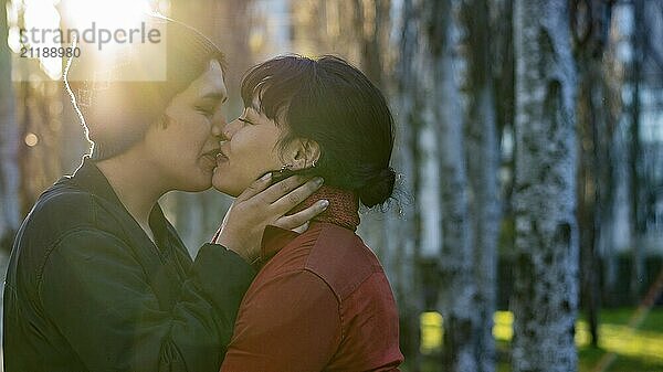 Young woman giving a kiss to her girlfriend's lips with ample copy space