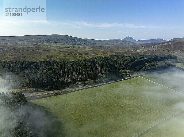 Coastal fog in the Scottish Highlands with hills  in the background prominent peak of Morven  Caithness  drone image  Broch of Ousdale  Berriedale  Scotland  Great Britain