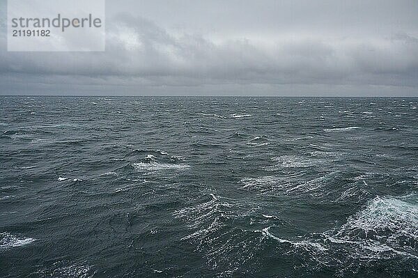 A stormy and turbulent sea under a cloudy grey sky  North Sea  Norway  Europe