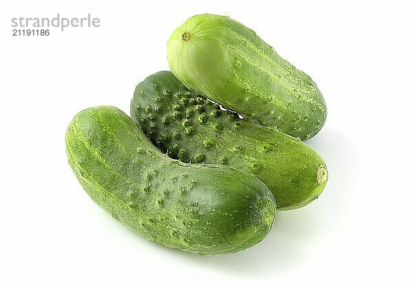 Three fresh cucumbers isolated on white background