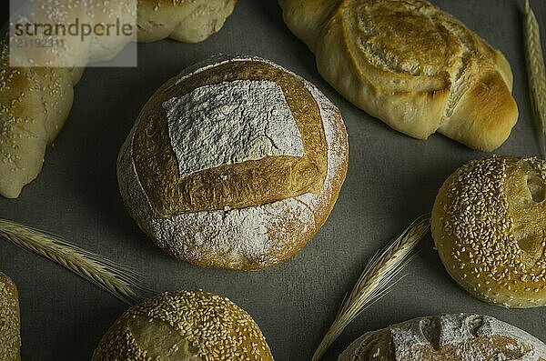 Beautiful Sourdough bread on gray background with dried wheat flower