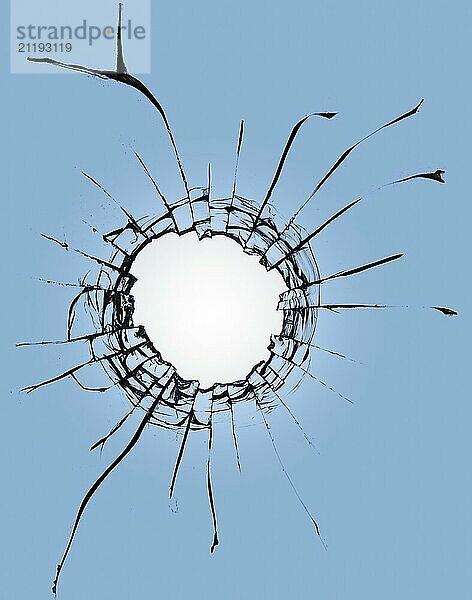 Broken glass with a hole on a blue background and with a light in the center. Texture of cracks on a broken window from explosions and gunshots