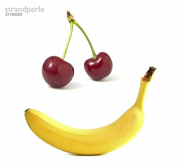 Banana and cherries isolated on white. Smile from fruit  face from food