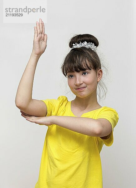 Girl raises his hand up on white background