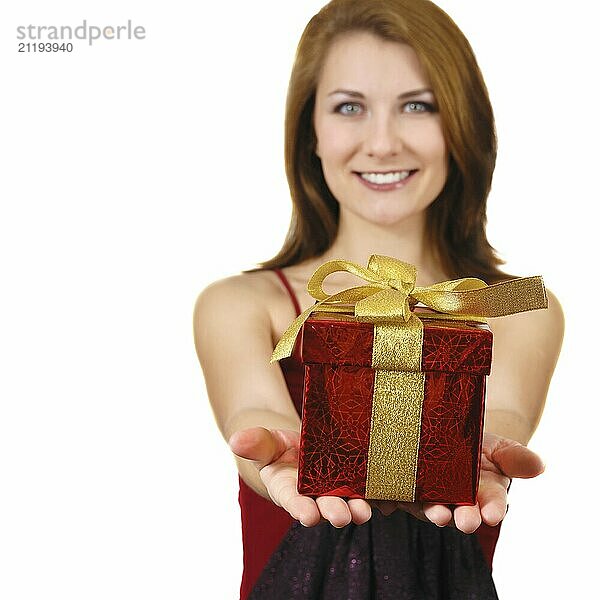 Beautiful smiling girl giving red gift box