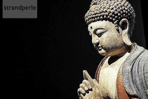 Buddha Statue  Concept of Zen  Spirituality  Peace. Copy space on Black Background  texture light