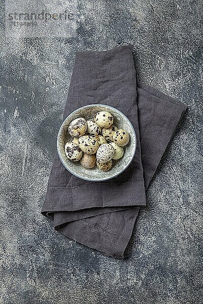 Food  Food  Quail eegs en bowl  gray background. Top view  copy space