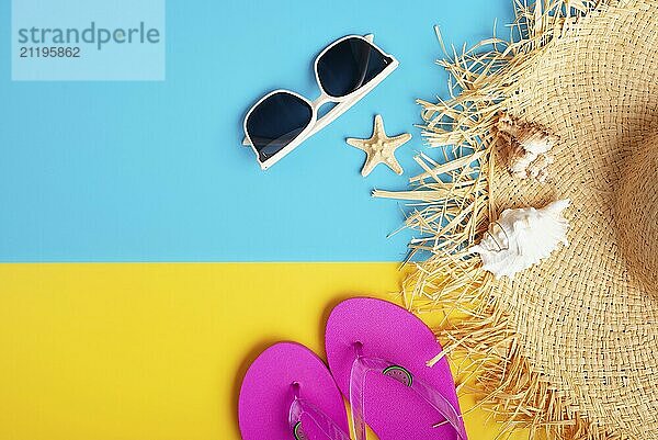 Straw hat sunglesses flip flops and shells on yellow and blue background vacation travel planning mockup