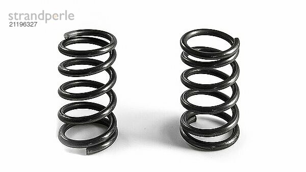 2 car springs on a white background. Isolated spare parts for vehicle repair