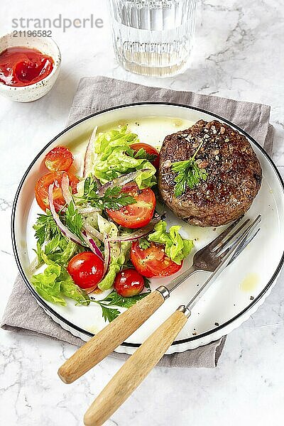 Food  Food  Beef hamburger with lettuce tomato salad on white plate  top view