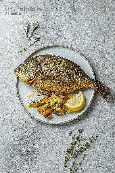 Food  Food  Grilled sea bream or dorada on gray plate. Gray background