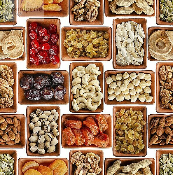 Seamless flat lay food background of dehydrated fruits  seeds and nuts on white. Non-perishable antioxidant gluten free foods concept