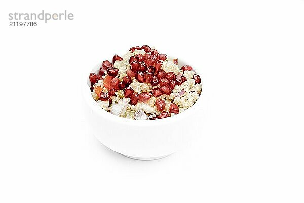 Quinoa salad with pomegranate seeds  radiccio  cucumber and olives on a white background