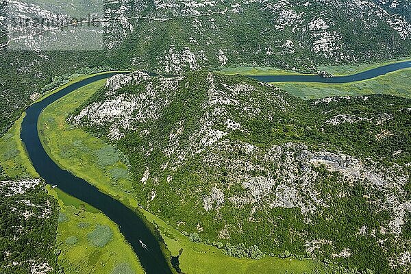 Aerial view of Rijeka Crnojevica  boats on beautiful river between mountains flowing into Skadar Lake  Montenegro  Europe