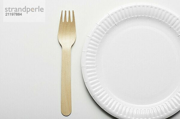 Wooden single use kitchenware and paper plate on white background simple view