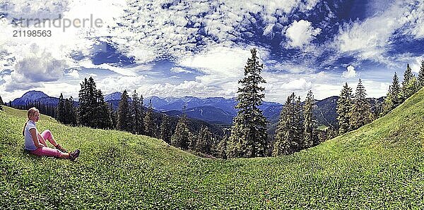 Girl in a meadow with the Blaubergalm  Tyrol  Austria Girl in a meadow with the Blaubergalm  Austria  Europe