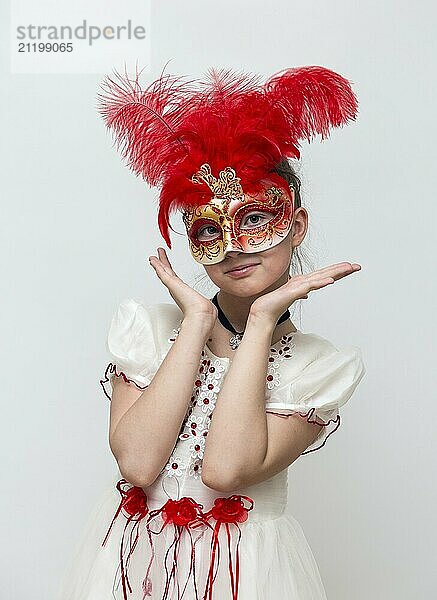 Adorable little girl with Venetian carnival mask on white background