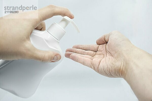 Hygiene to protect human health from viruses  hand washing with soap process. On pink background