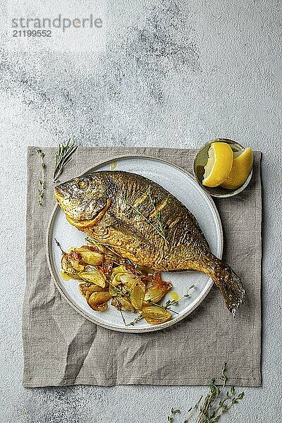 Food  Food  Grilled sea bream or dorada on gray plate. Gray background