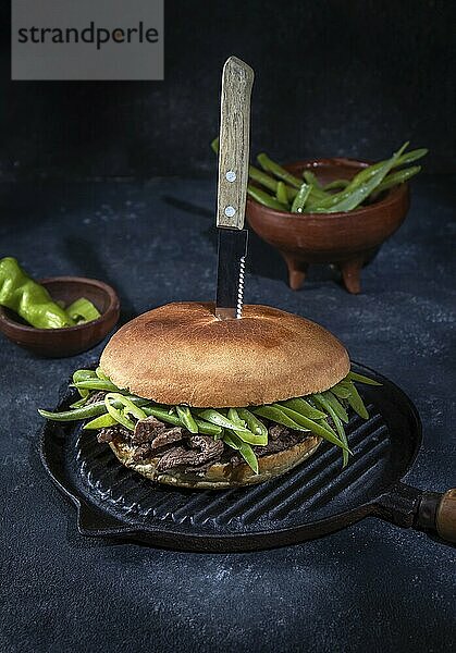 Food  Food  Chilean Latin american sandwich burger Chacarero with premium beef slices and green bean on black background