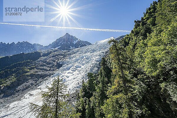 View of glacier Glacier des Bossons with sun star  behind summit of Aiguille du Midi  Chamonix  Haute-Savoie  France  Europe