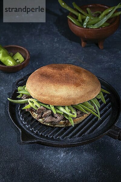 Food  Food  Chilean Latin american sandwich burger Chacarero with premium beef slices and green bean on black background