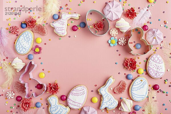 Sugar sprinkles  candies  Cookie cutters  Easter frosted cookies in shape of egg chicken and rabbit on pink background. Flat lay mockup with copy space