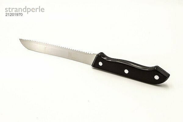 Chromium sawtooth knife with a black handle on a white background